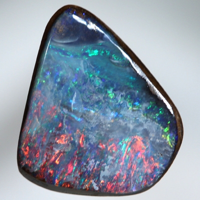 SOLID BOULDER OPAL Bright red sparkles over blue